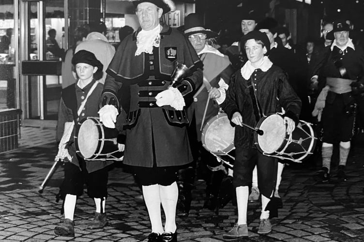 Newton Abbot town crier Ken Purchase leads the parade to start the town's Victorian Christmas Evening in December 1993
