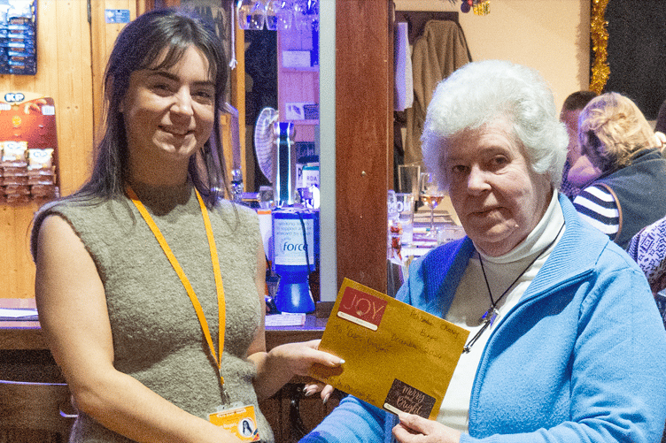 Carol Rowe presenting the cheque to Tegan Rogers from Pete's Dragons