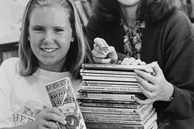 Young bookworm Joanne Holt receives her gold book award from librarian Jo Barber at Teignmouth Library in September 1995
