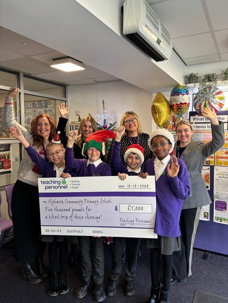 Children from Highweek Community Primary School celebrate winning a cash grant for their school trip.