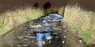 Fly-tipping blocks country lane 