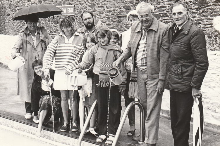Warming up the water with hot water from kettles at Buckfastleigh Swimming Pool on June 1, 1989