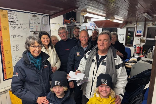 Captain Richard Kirkby hands over his donation to Teignmouth RNLI