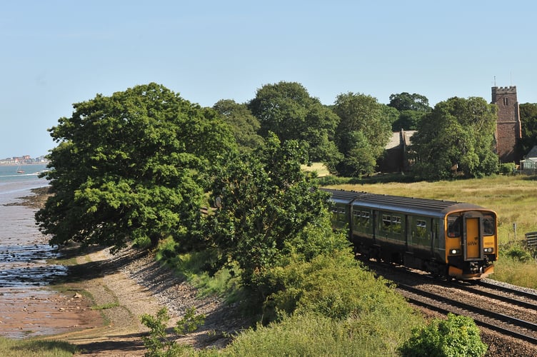 Trees near the line as the main line heads inland up the River Exe at Powderham