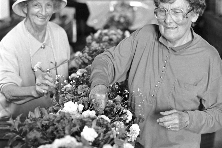 Frances Roberts and Joy Perriton enjoy the blooms at the annual flower festival held at Teignmouth's St Michael's Church in June 1994