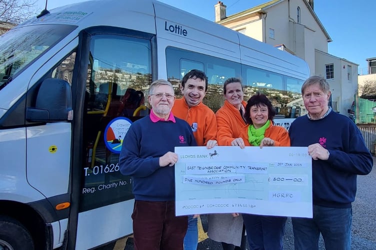 Pictured left and right are members of HGRFC Chris Cole and Martin Parsons with, centre Dawlish Community Transport team members Rowan Ford, Fritha Langdell and Sally Preston.