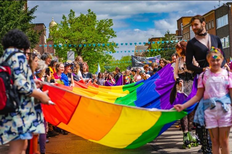 Carrying the rainbow flag at a previous Exeter Pride.