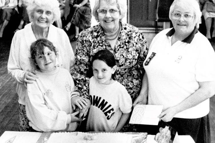 80th anniversary guiding celebrations in Teignmouth from June 1994. At the rear are Beryl Capner, Pam Milward and Margaret Shepherd - who was awarded a badge for 40 years as a Brownie Guider, while at the front Dana Bennett and Grace Chevell prepare to cut the cake
