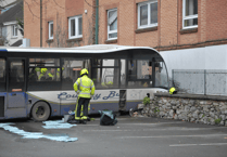 Driver taken to hospital as bus crashes into car park