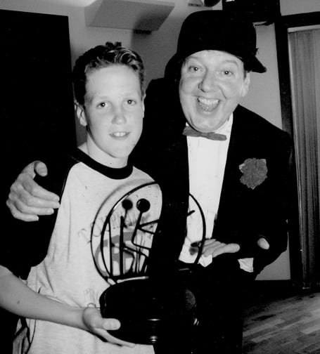 Young swimmer Russ Aplin from Hennock receives his trophy from comedian Jimmy Cricket after completing 162 lengths of Totnes Swimming Pool at a charity swimathon event