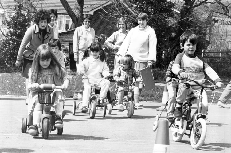 Youngsters taking part in a charity sponsored wheels and ride event at Bishopsteignton Primary School in April 1986