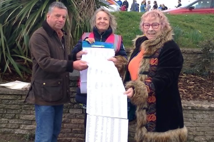 Alison Ford hands over the petition to Teignbridge District Councillors.
L-R Councillor Pete Williams, Alison Ford and Councillor Joan Atkins.
