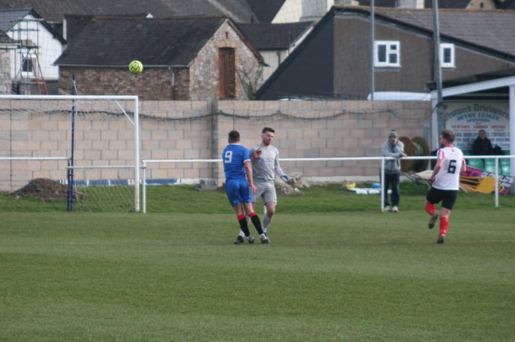 Toby Pullman is taken out by the Elburton goalkeeper