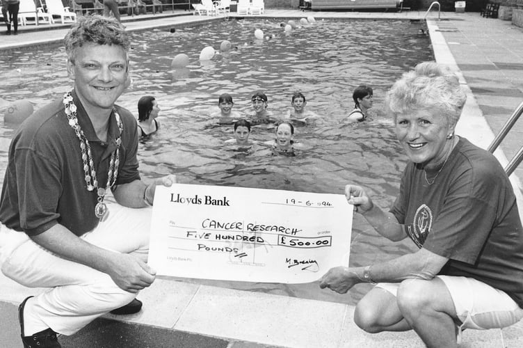 Cancer Relief was £500 better off thanks to a 24 hour swim held at Bovey Tracey Swimming Pool in June 1984. Here Bovey mayor Cllr James Mann hands over the cheque to Anne Crosby, the secretary of Bovey's Cancer Research League