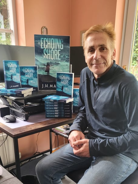 Jason Mann with copies of his award winning mystery 'The Echoing Shore'.