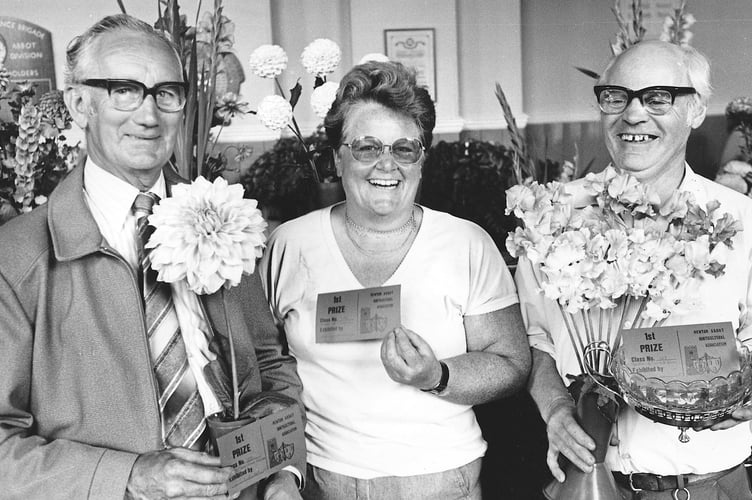 Blooming marvellous at Newton Abbot Flower Show in September 1987. Pictured here from left are George Eastwood who gained a first prize for a single bloom dahlia, Patricia Hunt who had the top hanging basket display and  Gerry Parker who picked up a first for his sweet peas