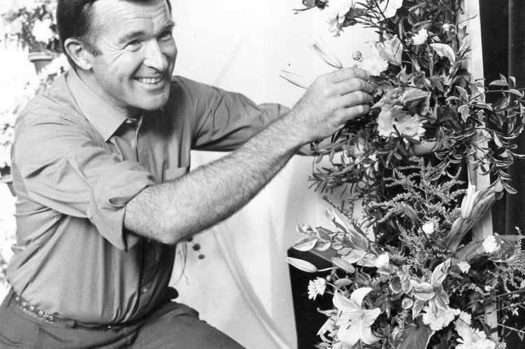 Bev Davies, co-ordinator of Bovey Tracey Methodist Flower Display and Craft Fair puts the finishing touches to one of his creations in August 1987