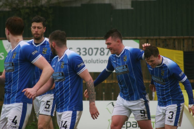 Buckland Athletic players celebrate a Ryan Bush goal against Wellington
