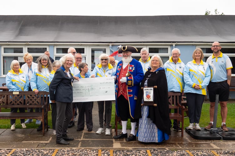 Marina bowlers, town crier and his lady consort with a cheque
