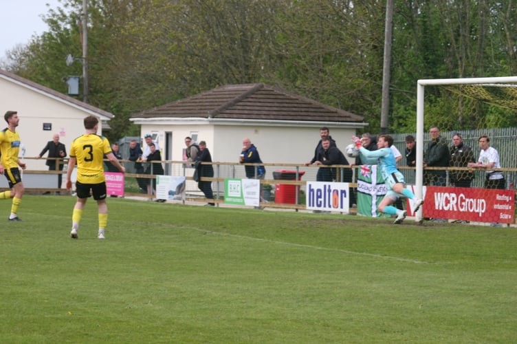 Adam Seedhouse-Evans makes a great diving save for Buckland