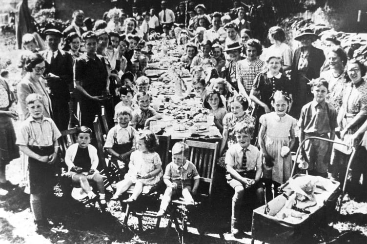 VE Day celebrations from May 1945. Street party in progress at Highweek