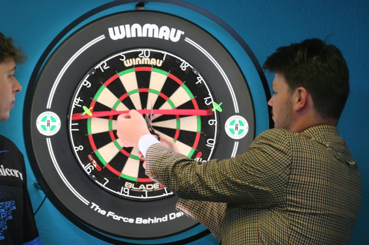 Mayor Alex Hall cuts the Teignbridge Darts Academy ribbon
