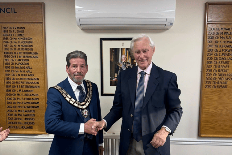 Councillor Dave Ripping formally accepts the chain of office from councillor Ron Peart as he becomes the new mayor of Kingsteignton