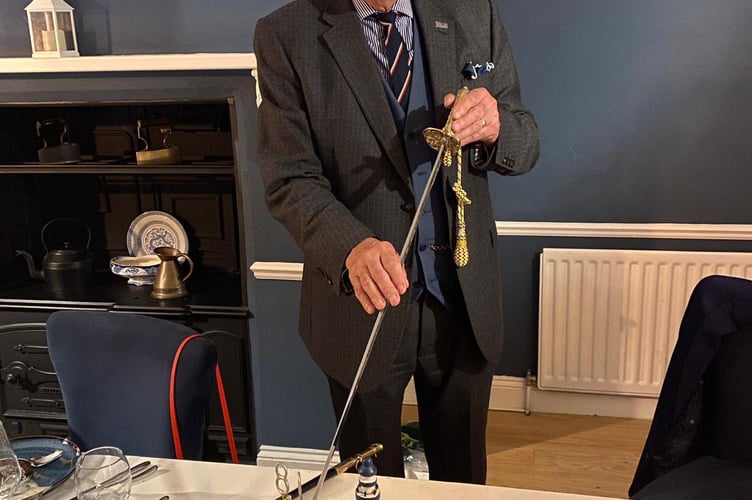 Commodore Richard Lord CBE cuts his 80th birthday cake