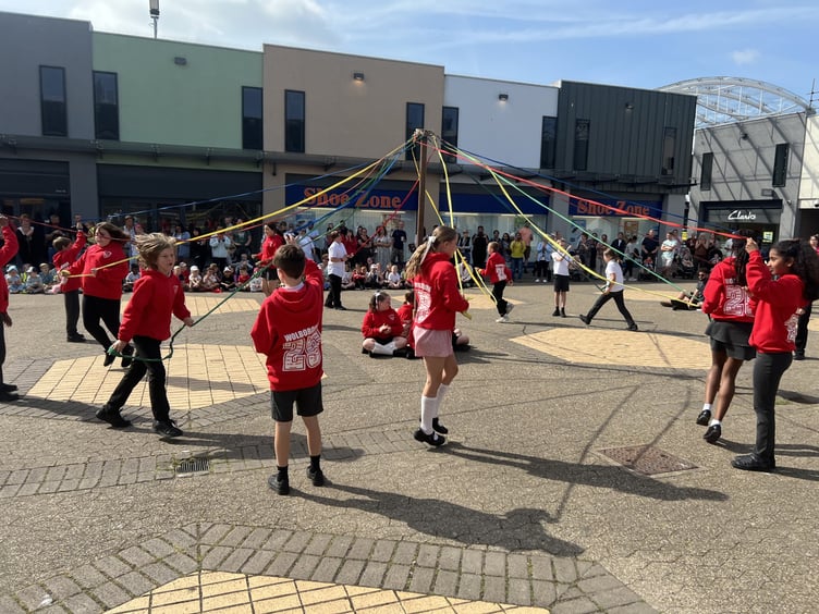 Wolborough School pupils dance around the May Pole in the Market Square, Newton Abbot.