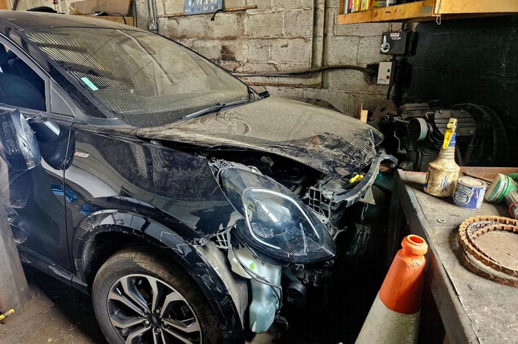 The car came to a rest inside a commercial garage 