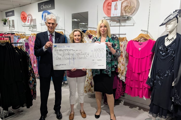 David Austin, Nicola Ireland and Christine Llewellyn with the proceeds of a fashion show being handed to the Donkey Sanctuary. 
