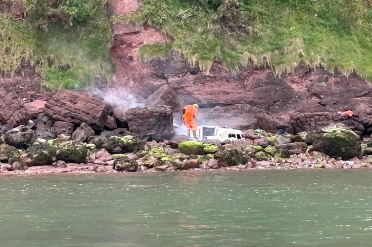 Workers removing the remains of a wrecked yacht by the Ness