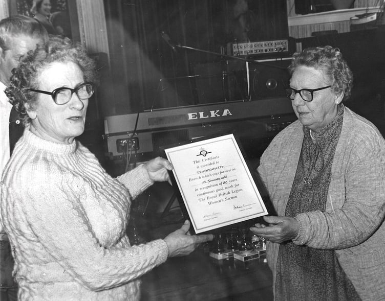 Teignmouth Royal British Legion. Gwen Tidball, chairwoman of the ladies section presents a certificate to Mrs M Millen, president of the ladies section, to commemorate her years of service in April 1986