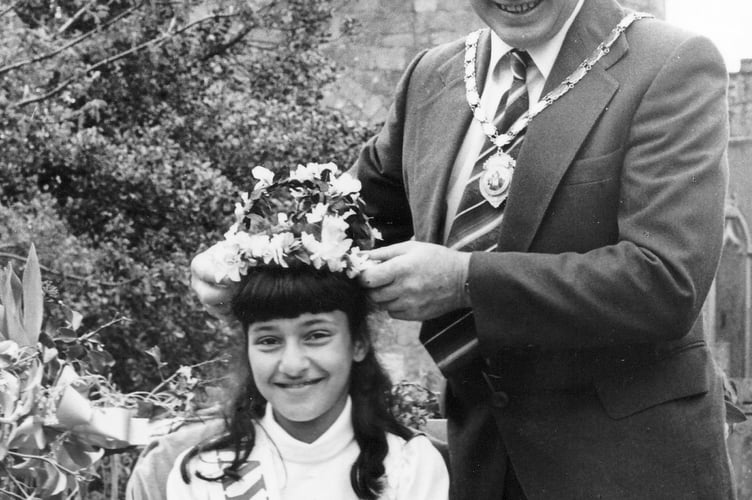Crowning of the May Queen in Moretonhampstead. Owen Chudley, chairman of the parish council, places the crown on the head of Cornelia Angell-Reiners in May 1987