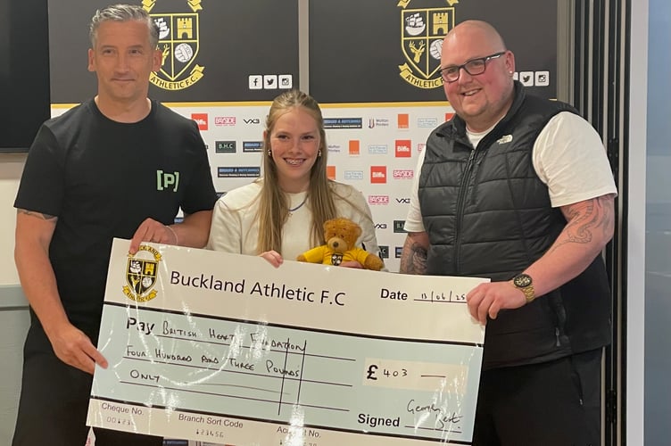Buckland U16 coach Ben Williamson, Ella Halfyard and assistant coach Rob Redding with the cheque for the British Heart Foundation