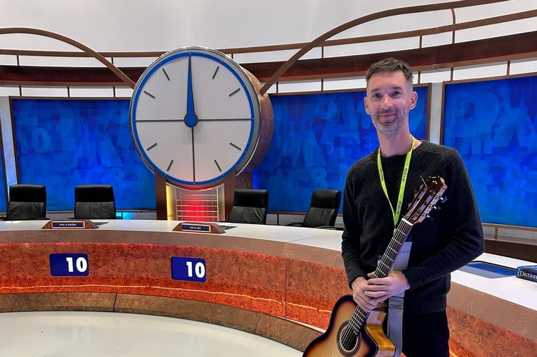 Teignmouth Flamenco guitarist Adam Westcott on the set of '8 out of 10 cats do Countown'