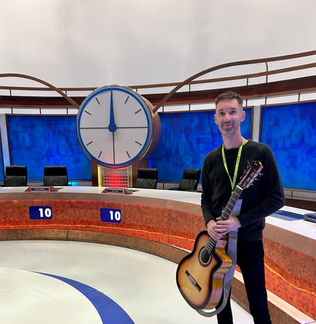 Teignmouth Flamenco guitarist Adam Westcott on the set of '8 out of 10 cats do Countown'