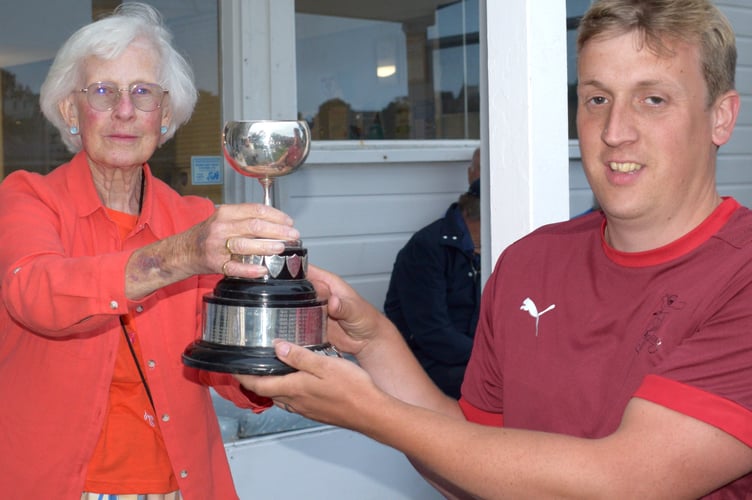 Ipplepen's cup-winning captain Ash Harvey collecting the Brockman Cup from Angela Glendenning, the last surviving grand-daughter of competition founder William Brockman.JPG