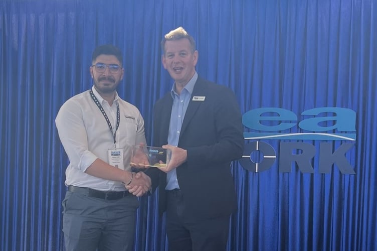 Teignbridge Propellers naval architect Arash Khalilnezhad receives the Seawork marine power and propulsion award from Tom Chant MBE, CEO of the Society of Maritime Industries.