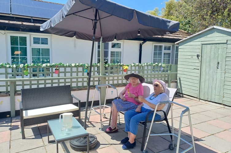 Mary Evans, left, and Jillian Sharp enjoy the new-look courtyard at White House Care Home in Teignmouth  