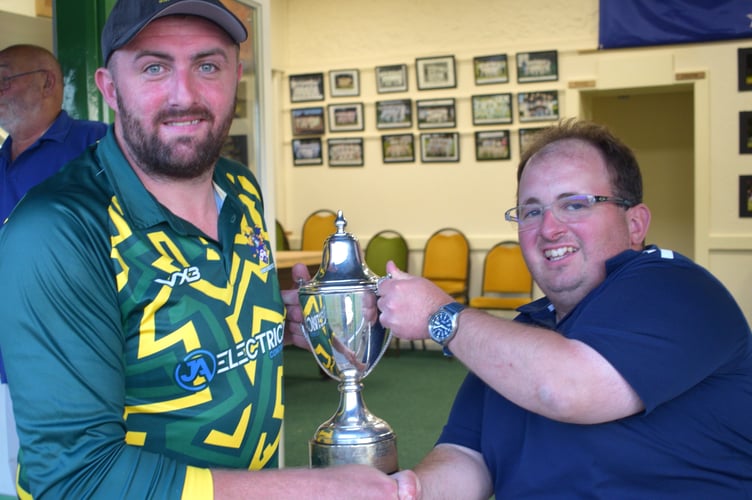 Bovey Tracey captain Dan Green (left) collecting the Aaron Printers Narracott Cup from competition secretary Mark Lovell