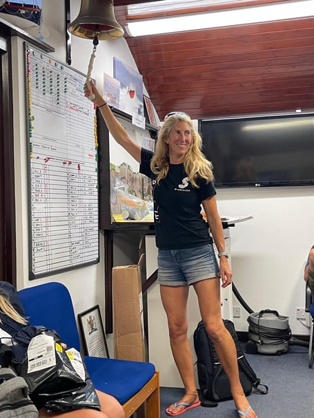 Rachel Palmer reaches for the bell to mark the completion of her Tier 2 training. Photo: Amy Furlong