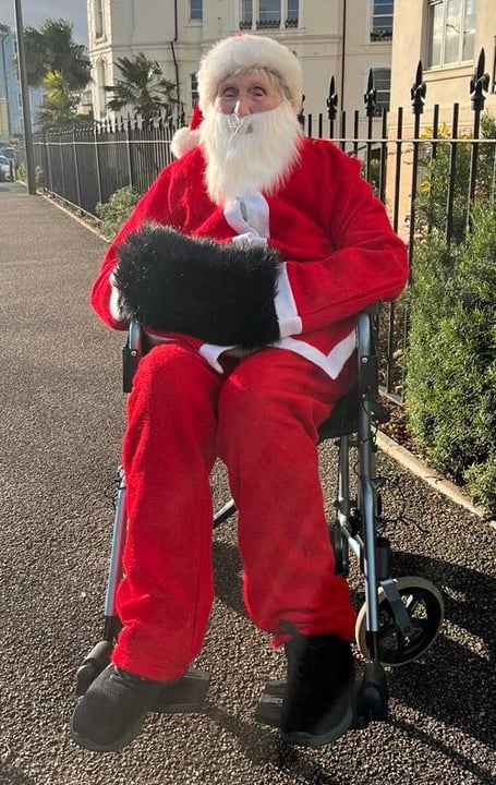 Joan Aplin dressed as Father Christmas. 