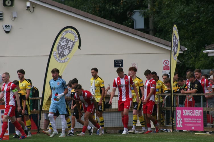 Buckland Athletic and Newquay AFC players walking out