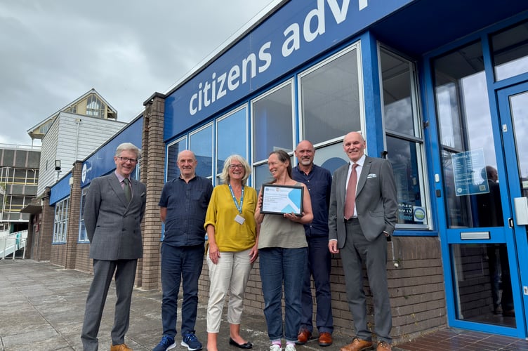 Staff from Citizens Advice Teignbridge receive the grant award from Devonshire Freemasons outside the Citizens Advice office in Newton Abbot.