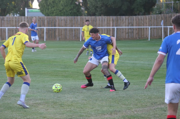 Newton Abbot Spurs goalscorer Brad Crocombe on the ball.