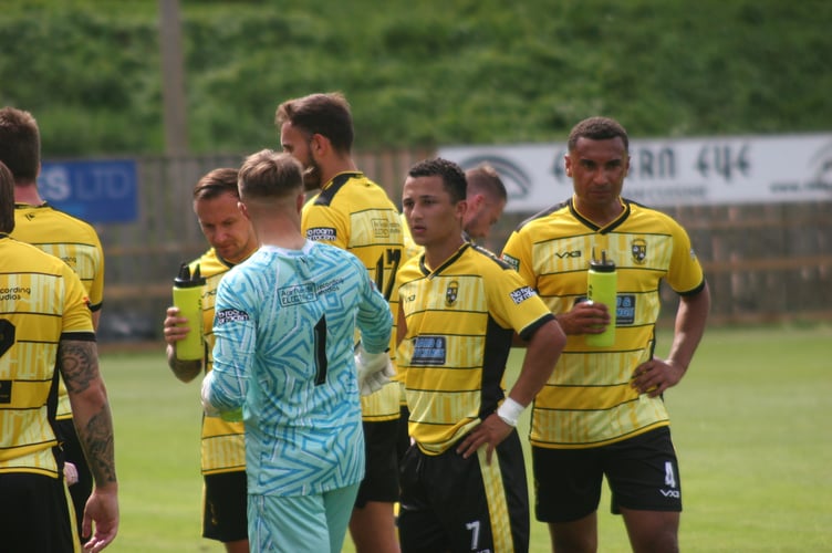 Buckland Athletic players take a break in the heat