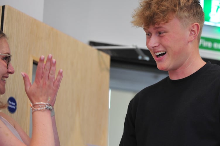 A Levels results day at Newton Abbot College. Student James Warburton celebrates his results with Head of Sixth Charlotte Tonge. James said he was happy with his results and although had a place at university has elected for an accounting apprenticeship with Peplows