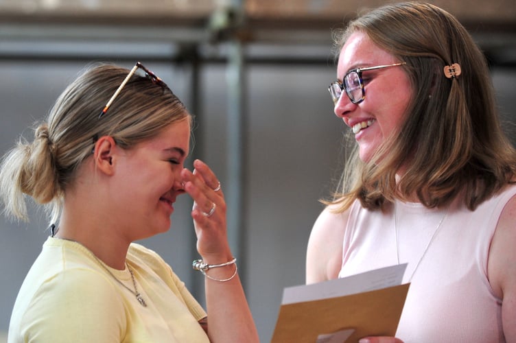 A Levels results day at Newton Abbot College. Cardiff University is the destination of Emily Ravenscroft where she will be studying Sports Science. She is pictured here opening her results envelope with Head of Sixth Charlotte Tonge.