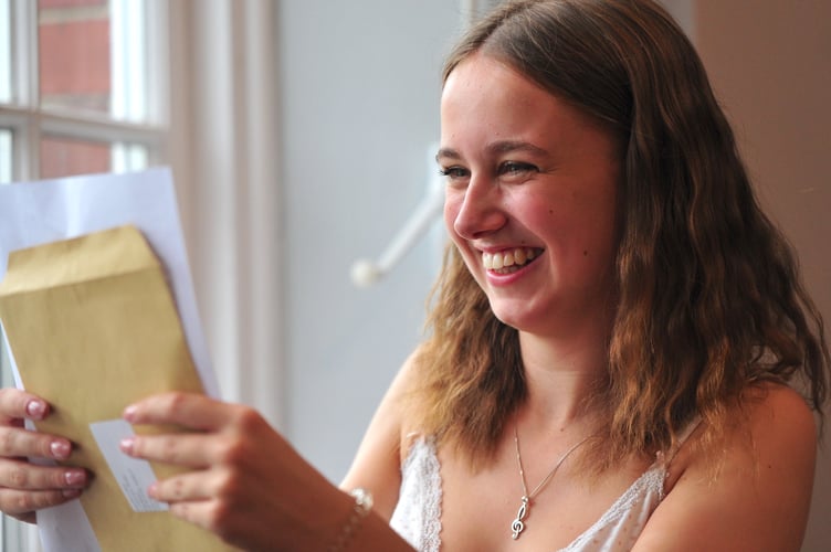 A Levels results day at Newton Abbot College.  Moment of trutch for Emilia Luker as she checks her results. Her three A-Levels will be taking her to Exeter University to study law - once she enjoys a gap year